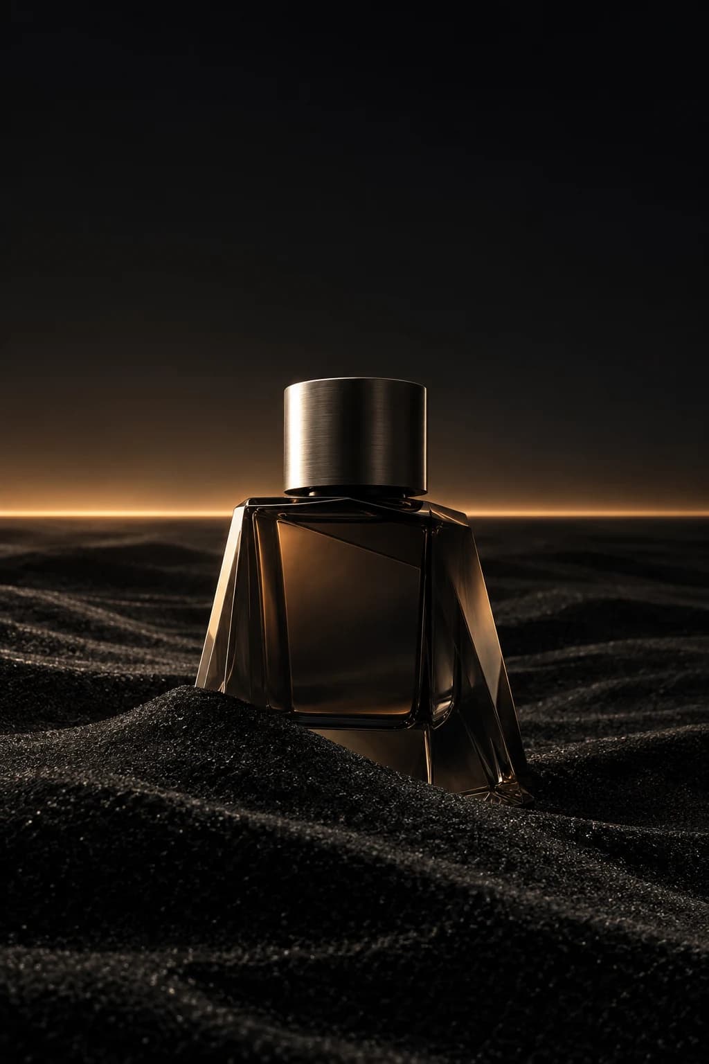 Unbranded smoked glass fragrance bottle in black sand